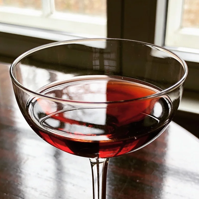 Red-wine coupe generated by Seedream 4.5 with exquisite in-glass refraction and a thin rim