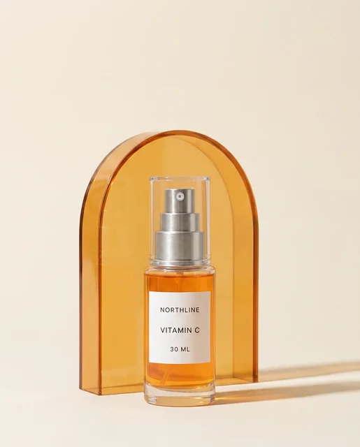 Accepted 4 by 5 product-world creative showing the NORTHLINE serum in front of a translucent amber arch