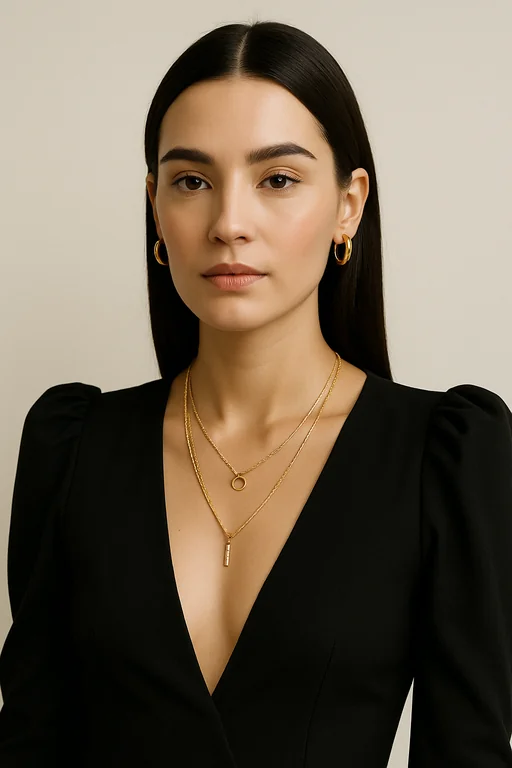 a woman posing against a plain light background, styled in an elegant and minimal fashion. She is wearing a black, deep
